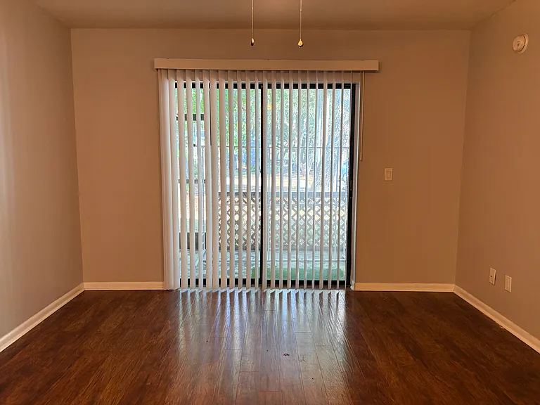 Den with new vertical blind and safety bar on sliding door