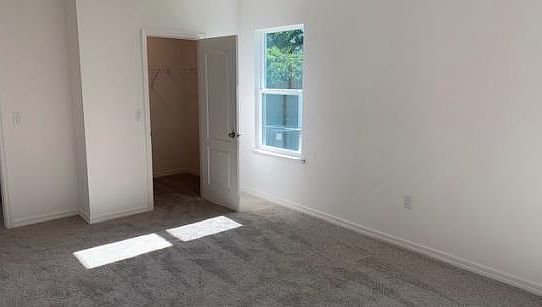 Huge master bedroom with plenty of natural light and large w