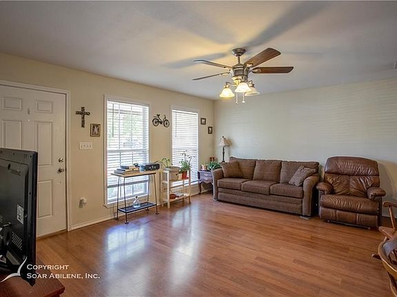 Wood laminate flooring throughout main living areas, and natural lighting through the entire home.