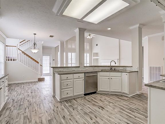 Gourmet kitchen features granite countertops, beautiful cabinetry and double ovens. Charming breakfast nook and island bar offer multiple seating options.