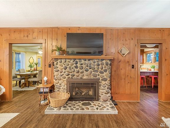 A beautiful gas fireplace warms this wonderful space. Entry to the formal dining room at the left, and the kitchen to the right.