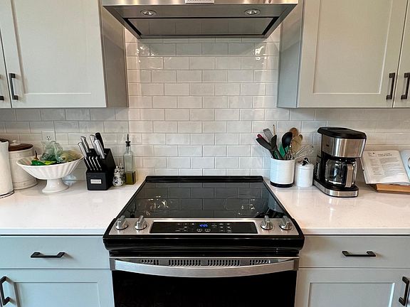 Electric range and stainless steel chimney hood