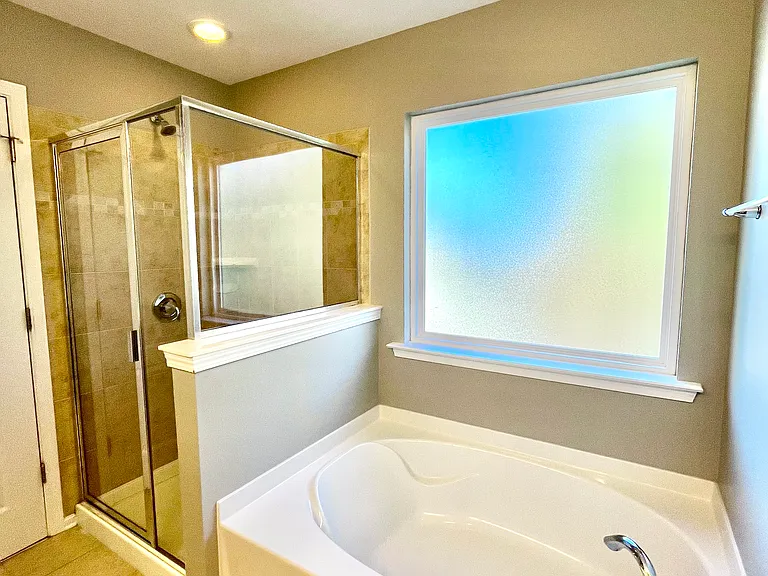 Master bath with tub, shower and separate toliet room