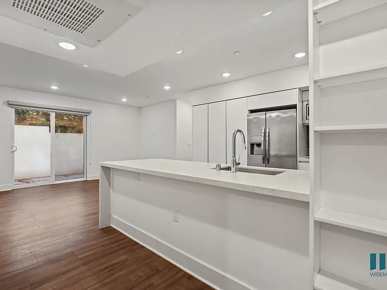 Open-Concept Kitchen, Dining, and Living Room Space with Built-In Shelving