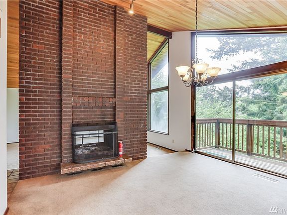 Vaulted ceilings with wide open windows to a deck off this large dining area.