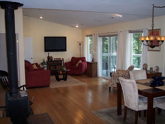 The living area features a gas fireplace; new bamboo floors; open floor plan; vaulted ceilings and the same stunning views