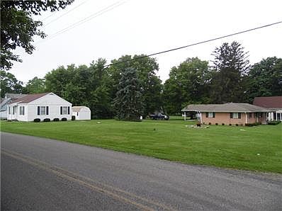 Side view from CR 600 shows all 3 parcel that are included.  The little white "summer house" is good for storage or a playhouse.  Could be updated for xtra living qtrs.