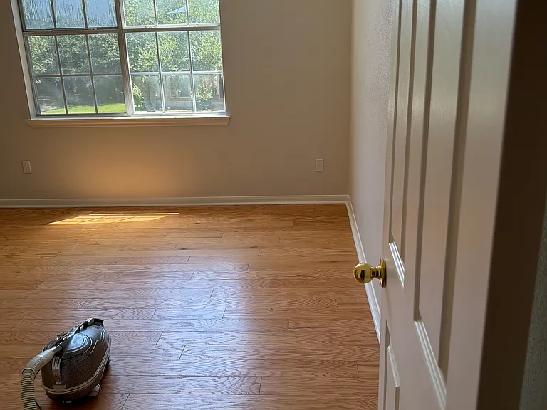 Upstairs Bedroom One with walk-in closet and arch window. This is a beautiful room, and, like the rest of the house, also has hard wood floors to add beauty and make it easy to clean. High ceilings, would be an amazing room for tall bookshelves.