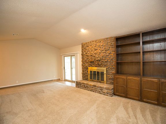 Huge Family Room boasts vaulted ceiling, updated carpet, updated paint, recessed lighting, built-in display cabinets and gas fireplace.