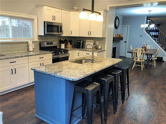 Spacious kitchen w/large island, all new stainless steel appliances, excellent natural light, white cabinetry, granite counter t