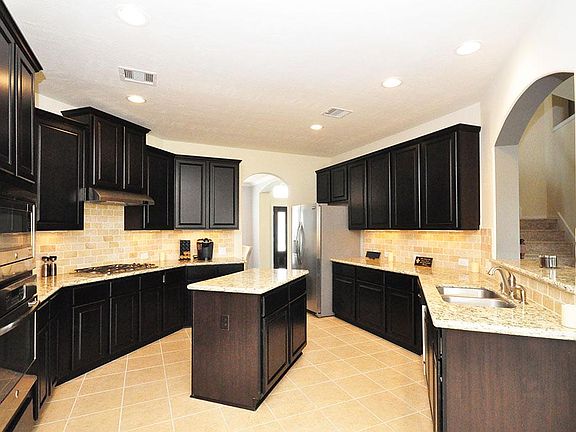 Gorgeous and large kitchen with rich cabinets & sparkling granite counters.