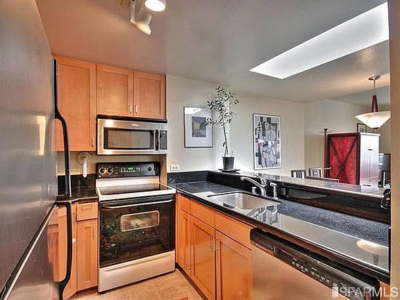 Kitchen with Electric Stovetop and built in microwave.