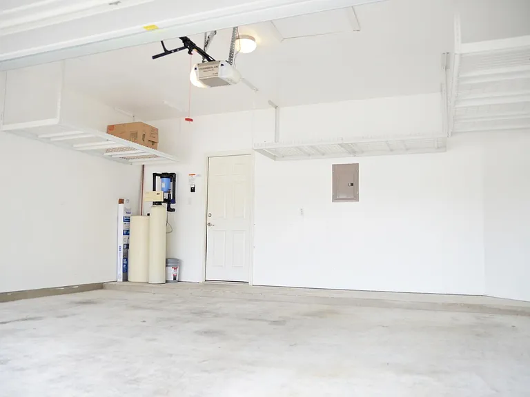 Note 3 large groups of heavy-duty hanging storage racks in garage. Water Softener system, and under-sink reverse osmosis system to fully purify drinking water