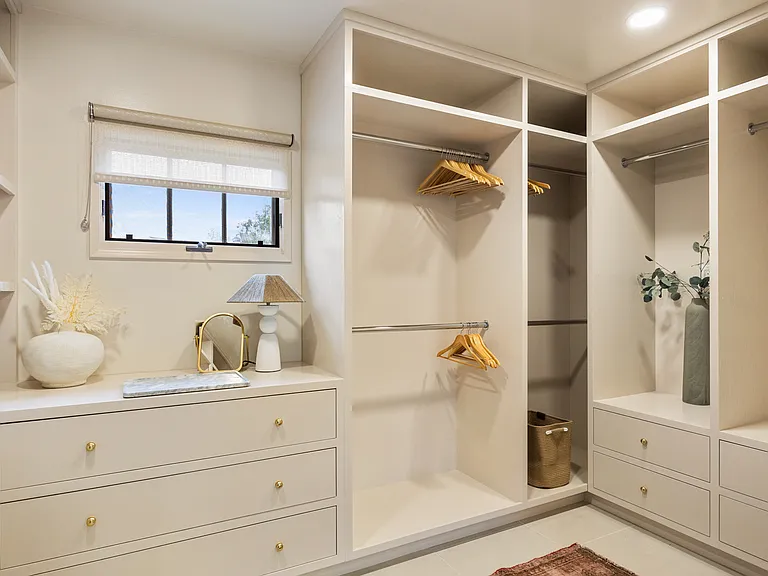 Elegant walk-in closet featuring built-in organizers and plenty of room for your wardrobe.