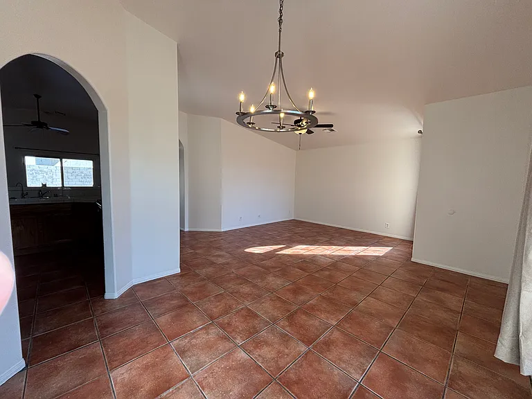 Bright, open living and dining area with tile flooring and plenty of natural light.