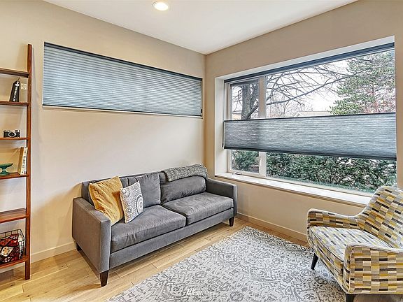 Enjoy the sunlight in the living room with gleaming wood floors 