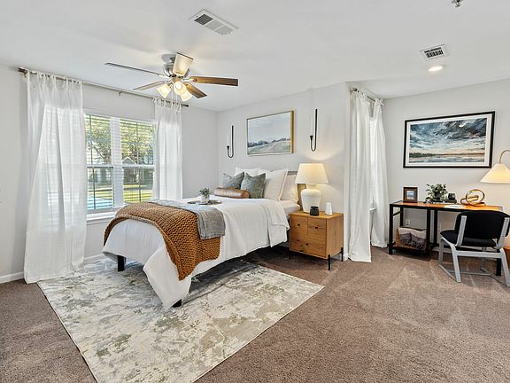 Bright Bedroom with Ample Natural Light and Ceiling Fan