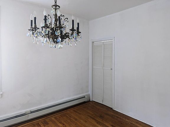 Antique Glass Chandelier and Shutter Door leading to bonus room