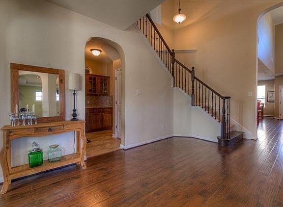 A sweeping staircase leads upstairs.