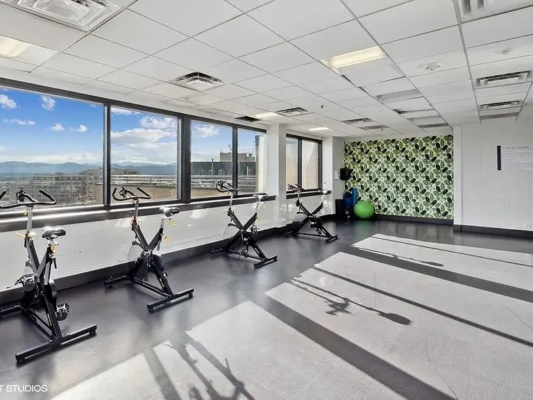 Exercise bikes with a stunning view in the fitness center at Archer Tower in Denver, CO