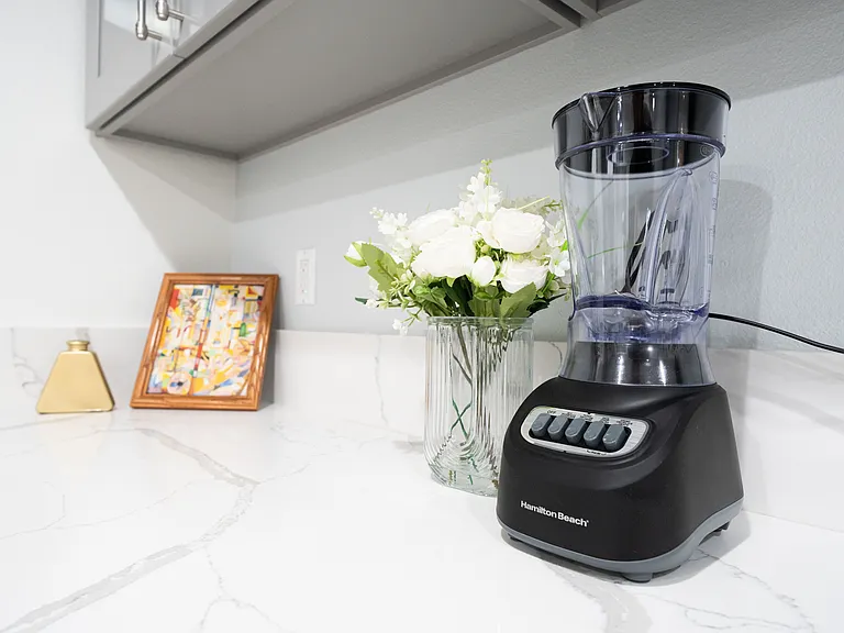 Sleek countertop space featuring a blender.