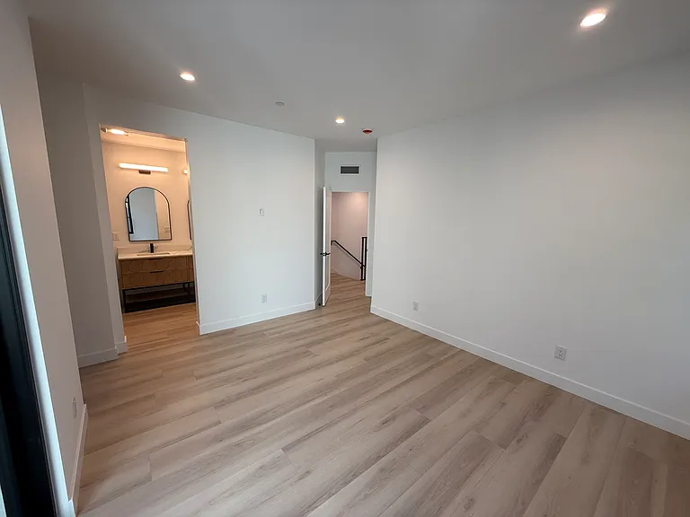 Large master bedroom with private patio and walk-in closet