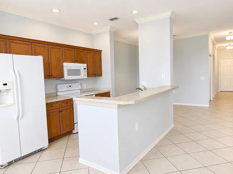 Spacious open-concept kitchen with breakfast bar overlooking the living area