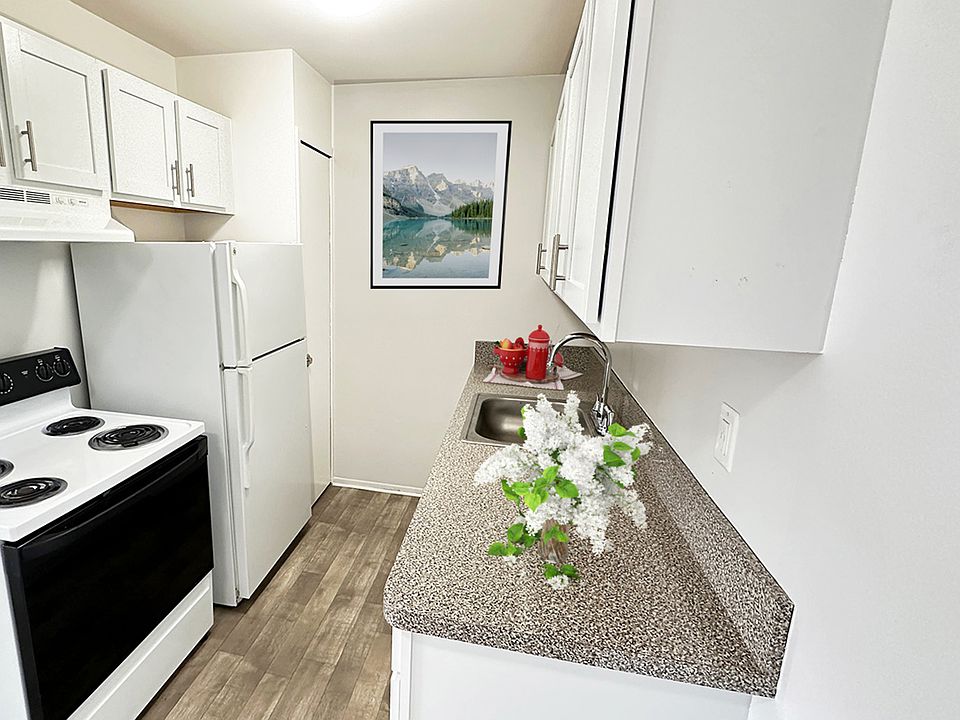 Gourmet kitchen with white shaker cabinetry, granite countertops, wood plank flooring --you&#39;ll not only make great meals here, you&#39;ll make memories in the gathering spot of your home.