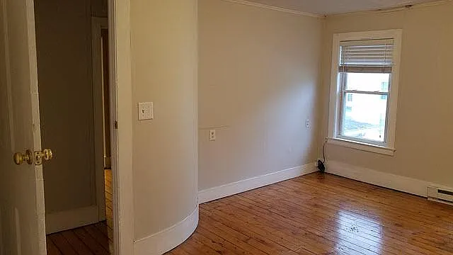 Bedroom 3 View 2 - Shows the curved wall and one of the windows.
