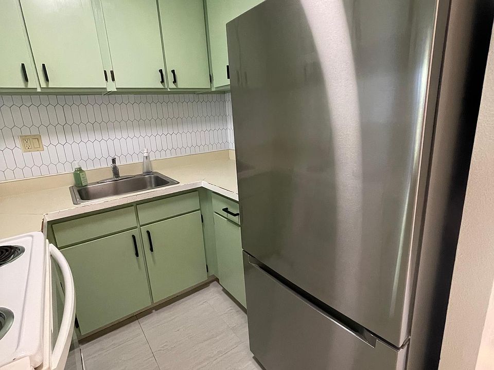 View of kitchen from main entry hallway.