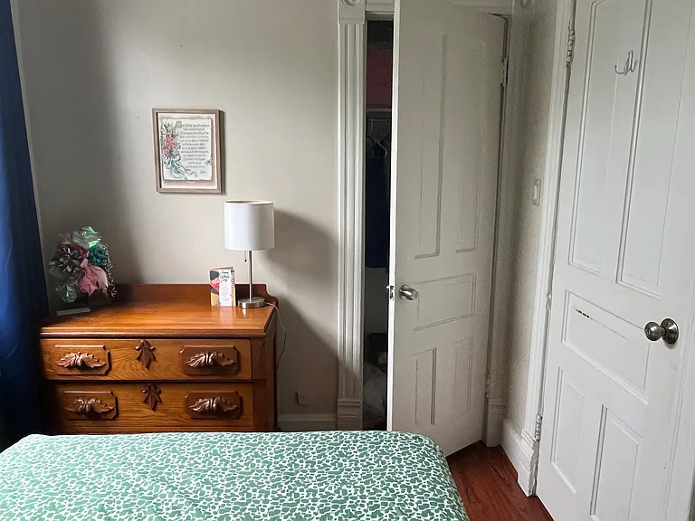 2nd floor west bedroom - shown with dresser and closet door cracked open.