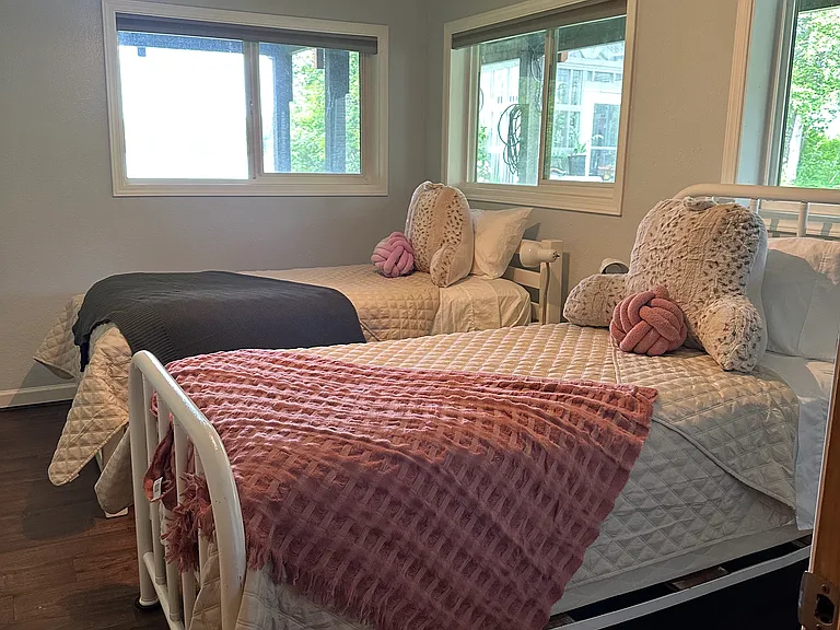 Basement bedroom with two twin beds.