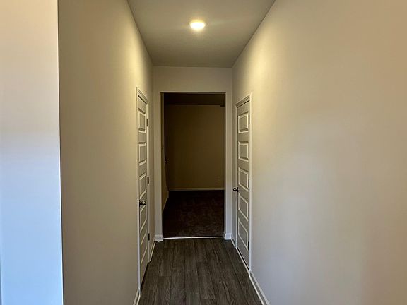 Bright hallway with modern floors and soft lighting that guides you into the heart of the home.