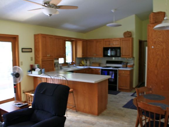 The kitchen includes a sitting room. : New flooring! Deck off of this area.