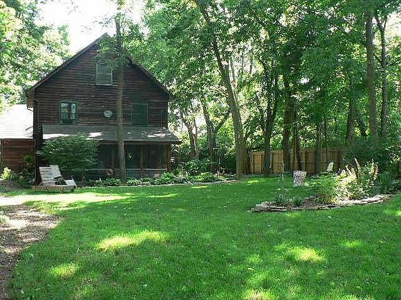 View of screened porch from large yard