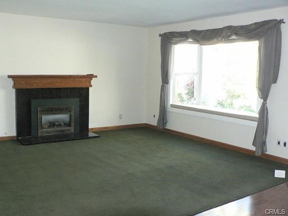 Large "formal" living room with bay windows and cozy gas firepla