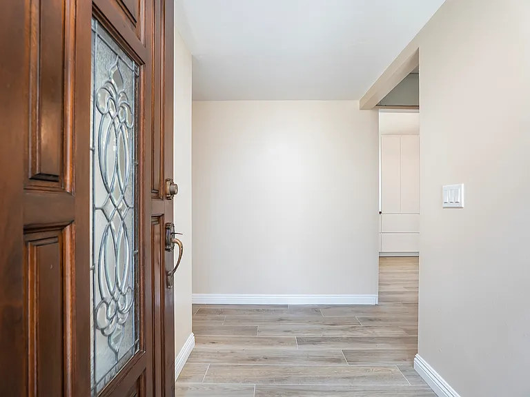 Beautiful intricate stain glass inlay front door, followed by reclaimed wood image porcelain tile.