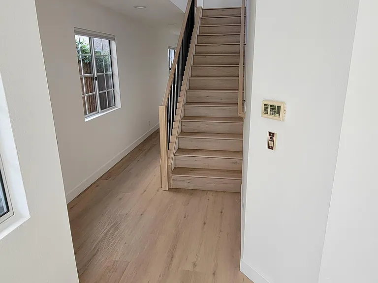 First floor view from living room with all new staircase.