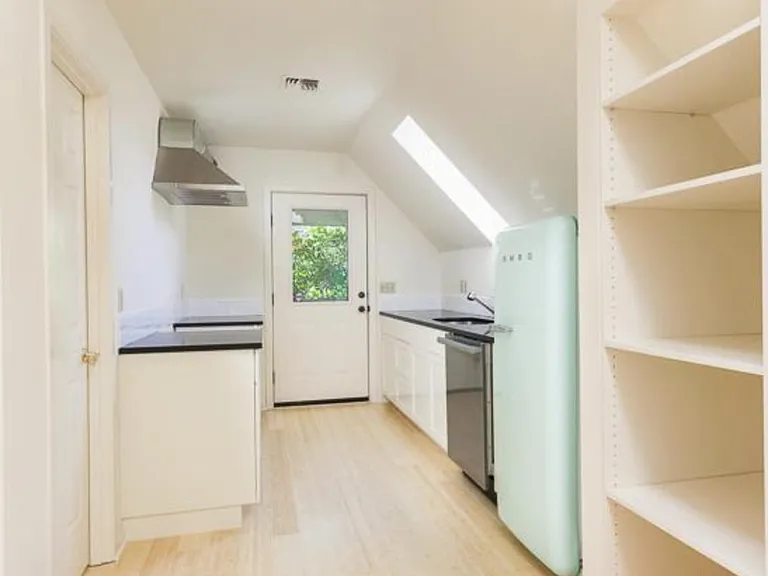 Gallery kitchen includes beautiful marble countertops, stainless steel appliances, and new retro refrigerator.