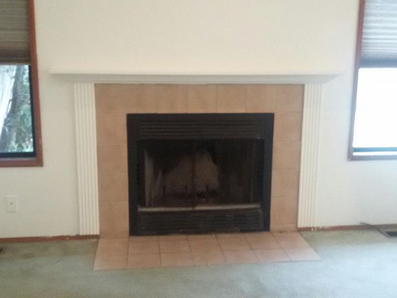 Gas fireplace in living room. New carpet coming.