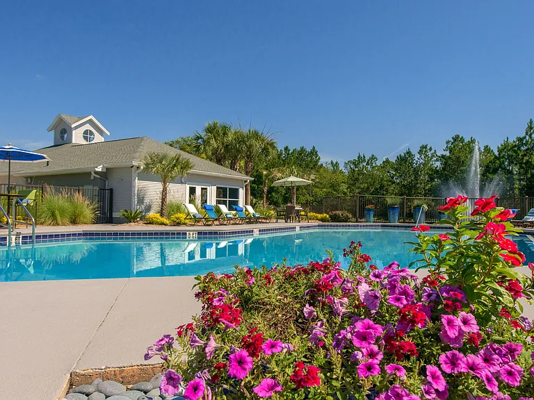 Relax and revel in the magic of our sun-drenched pool area. Lush landscaping frames this sun-soaked oasis.