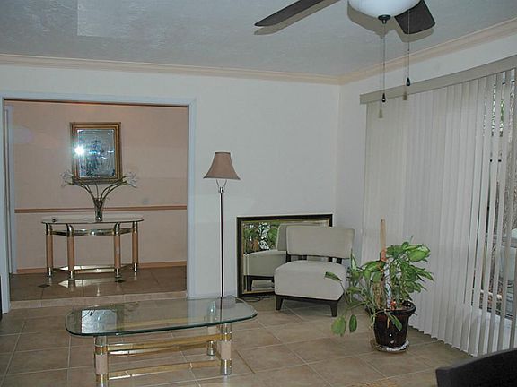 Formal Living room with huge window letting in lots of light.