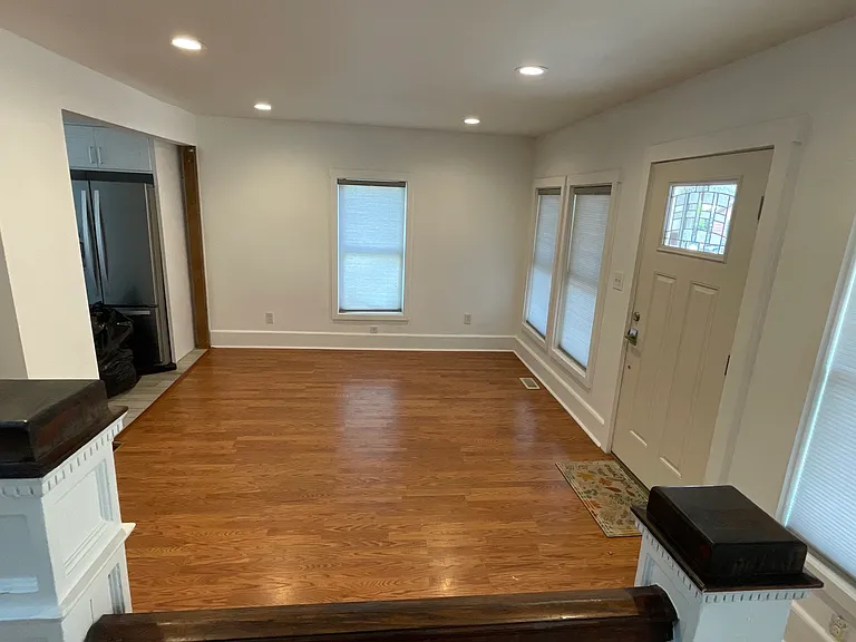 Large open living room with hardwood floors, recessed lighting, and flexible space for multiple furniture layouts.