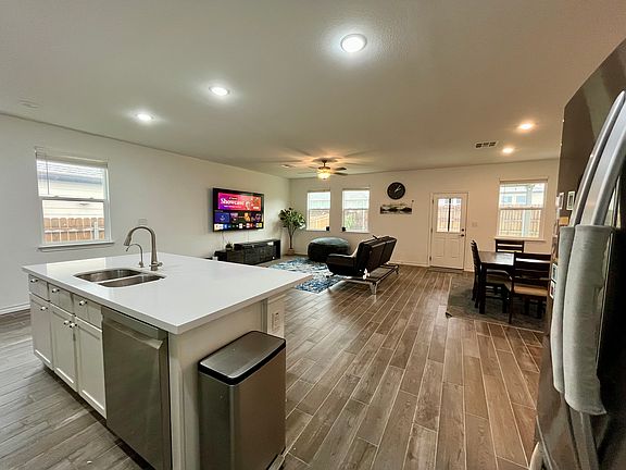 5. Living Room: Featuring a stunning wall mounted 86" LED TV and a 7.1 speaker+sub-woofer system.-Perfect for movie nights!