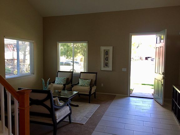 The stairs up to the loft on the left, the living room, and 