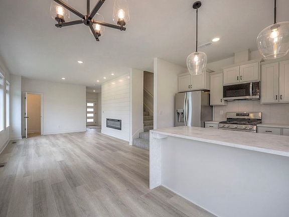 Bright Open Living Space with Electric Fireplace & Natural Light