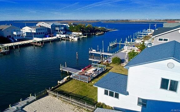 View of home with lagoon and bay
