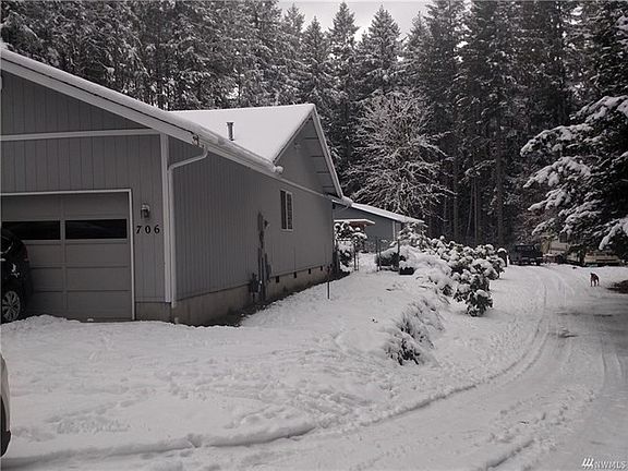 another view of the front of the home, showing the long driveway to the back of the property.  Plenty of room to park your boat or recreational trailer