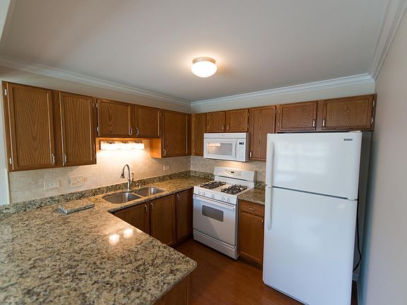 Kitchen with granite countertops and marble back-splash