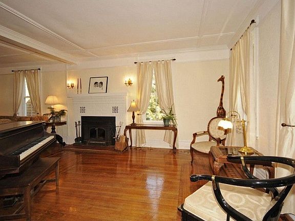 Spacious living room with in-laid hardwood floors.